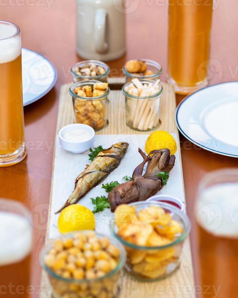 espadín, kilka pescado, salsa de tomate, patatas fritas y bocadillos de cerca foto