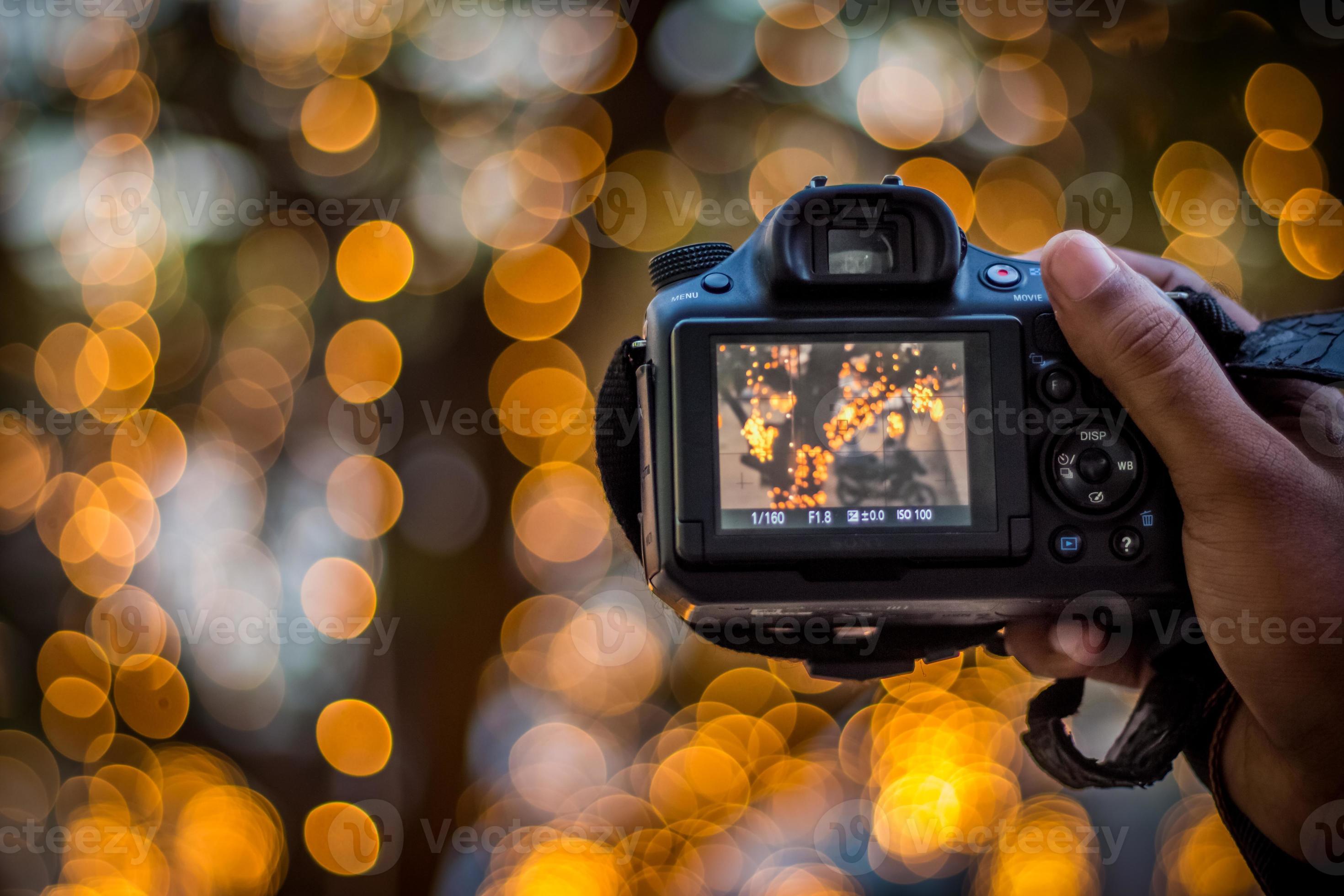 DSLR Camera on Bokeh Background Black DSLR Camera With Bokeh Lights