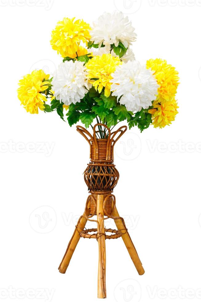 Artificial flowers and wicker wooden vase photo