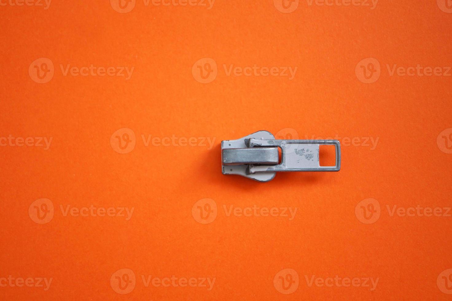 metallic zipper on the orange background photo