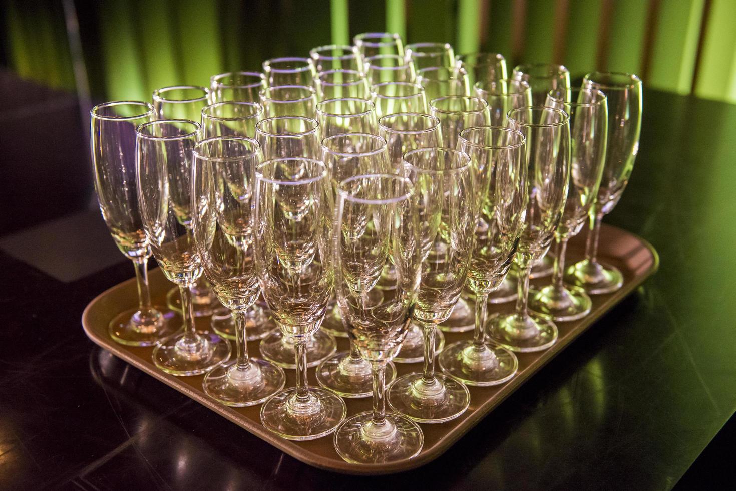 Rows of champagne glasses in wedding party photo