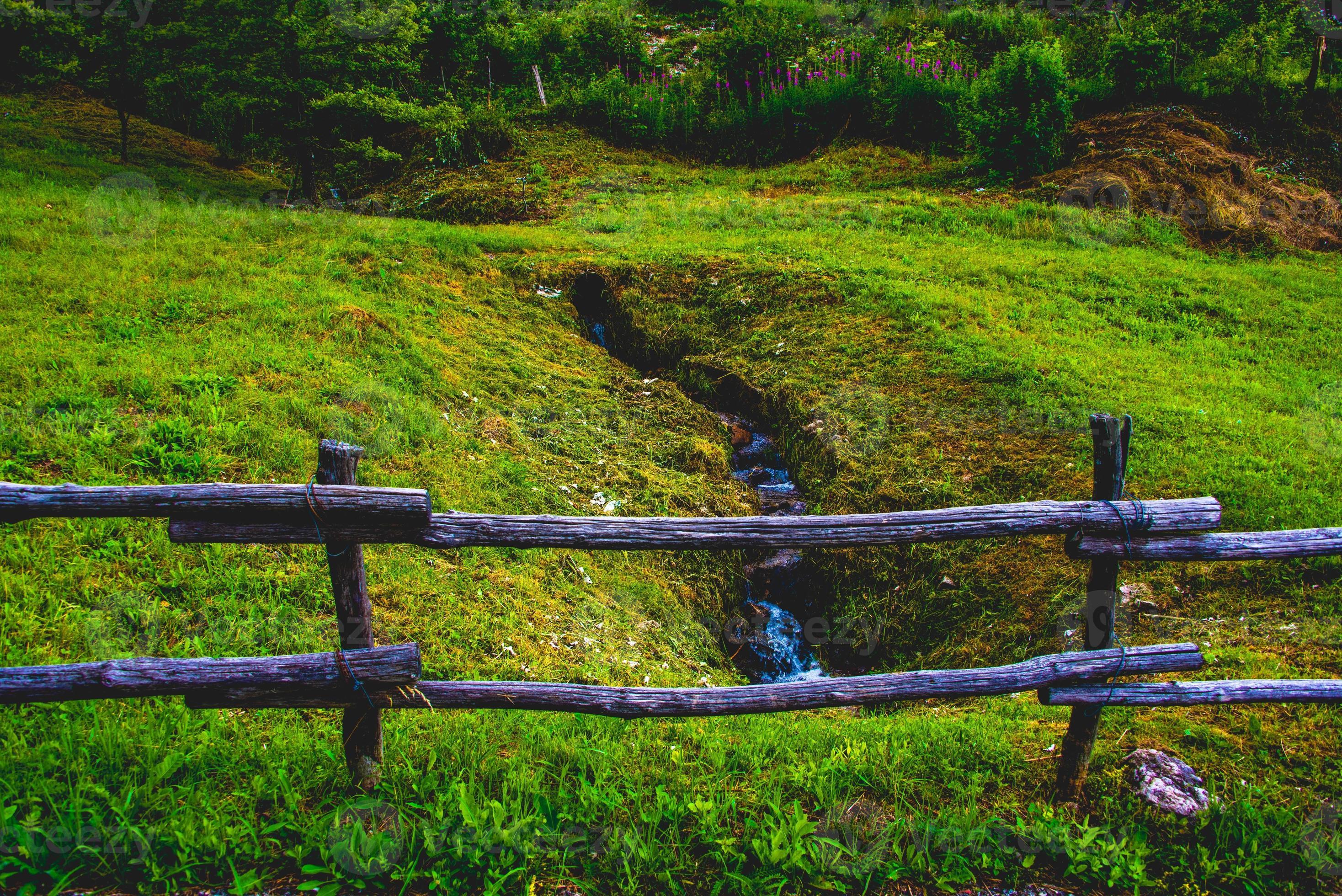 Meadow stream and wooden fence 2501525 Stock Photo at Vecteezy