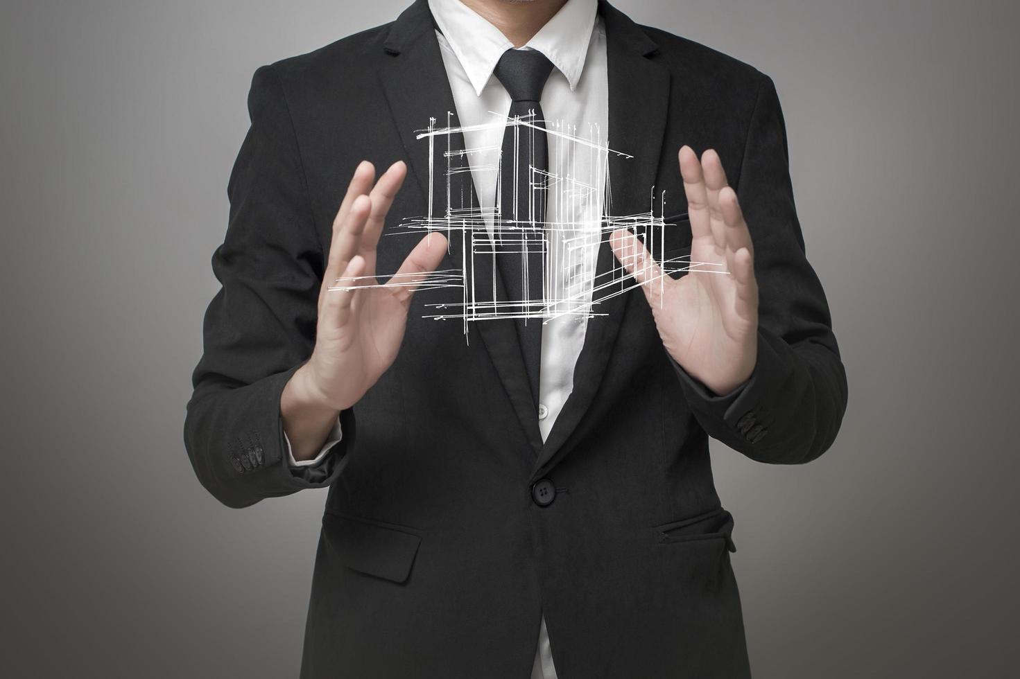 Businessman showing a model of the house photo