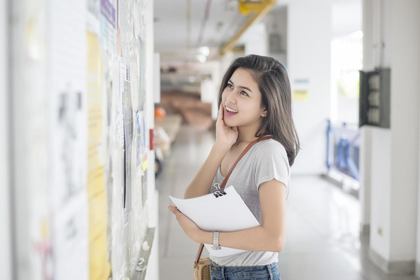 A female university student is exciting with the exam report photo