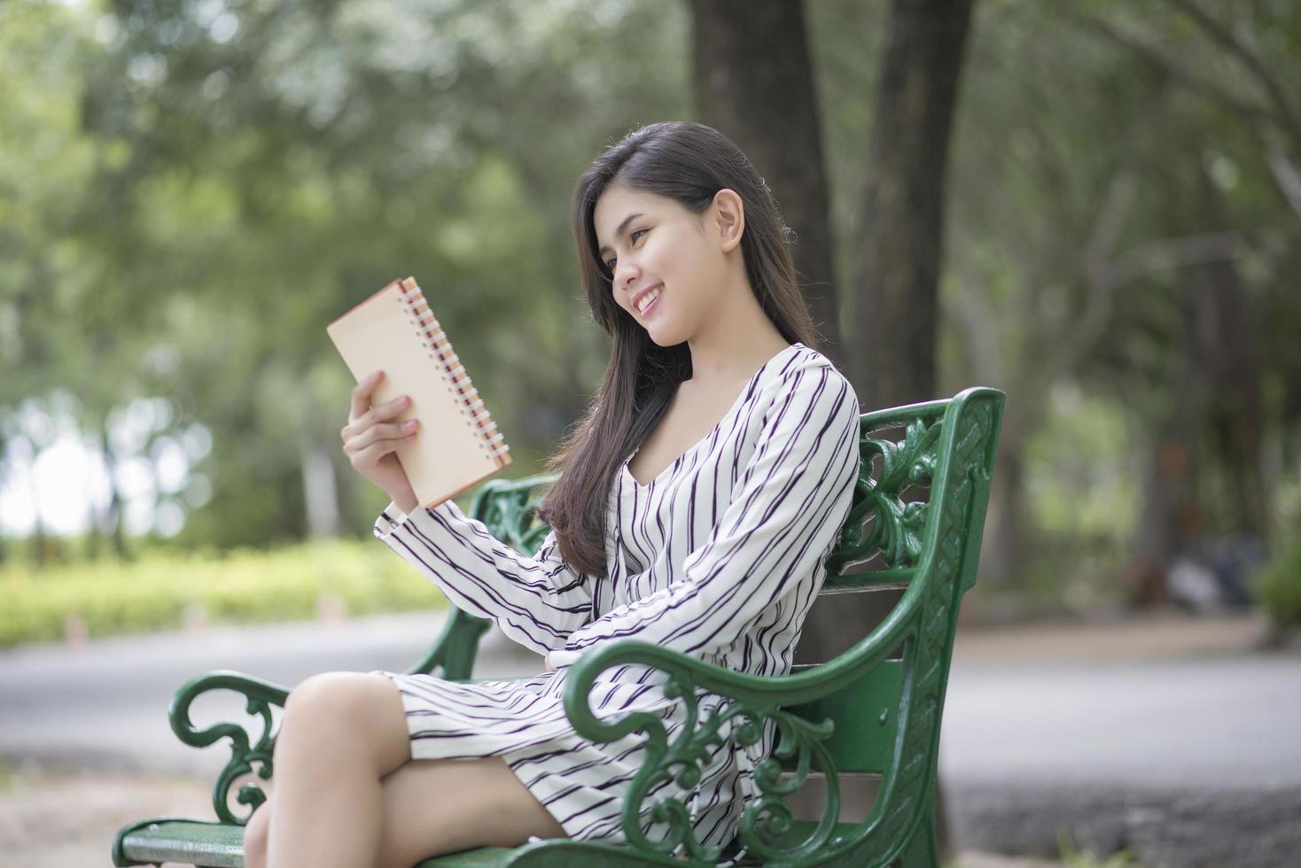 Attractive woman reading a book in the park photo