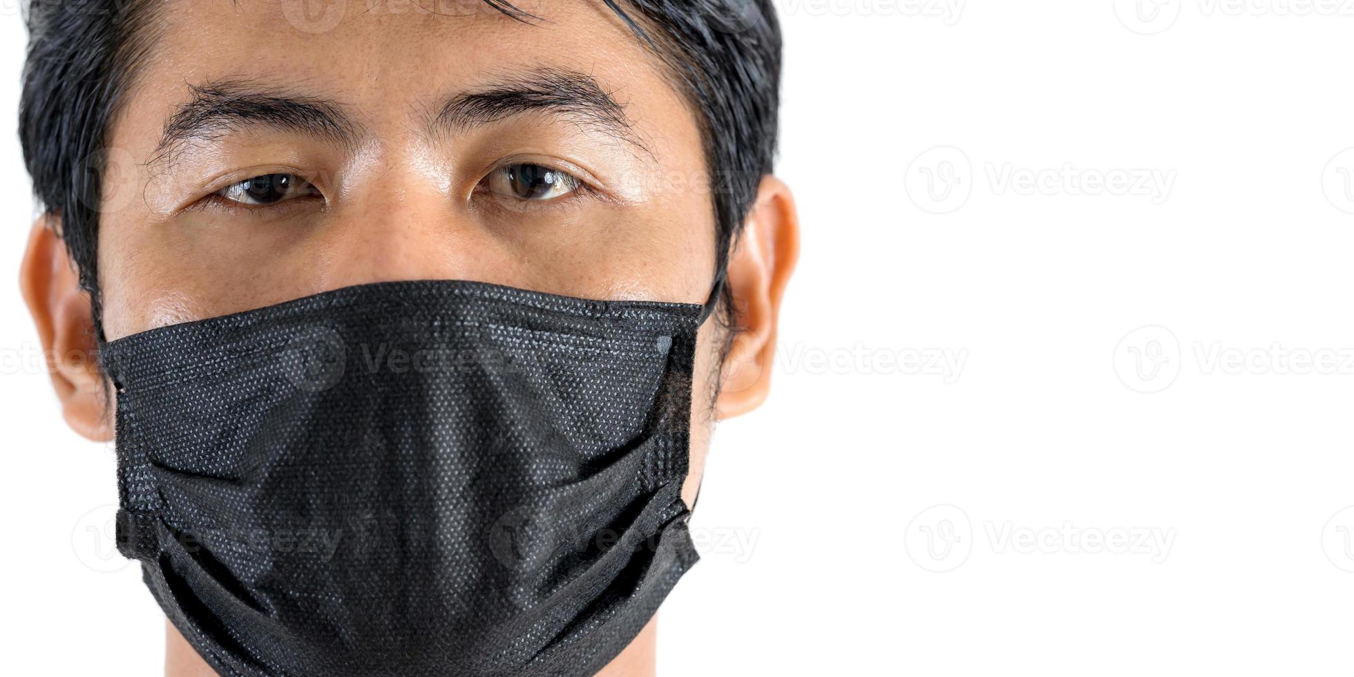 Close up portrait of man wearing protection face mask against coronavirus photo