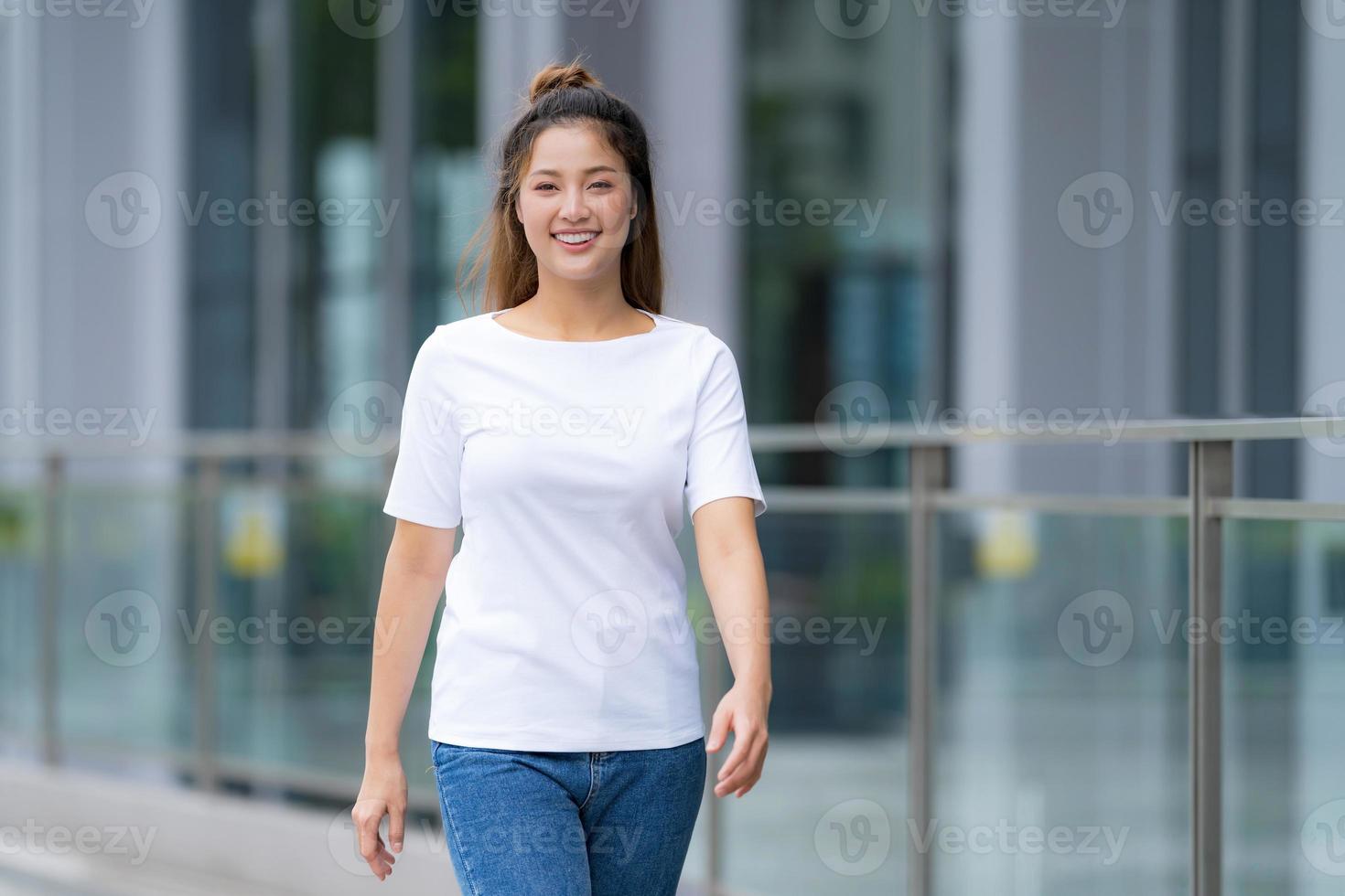 Woman in white t shirt and blue jeans photo