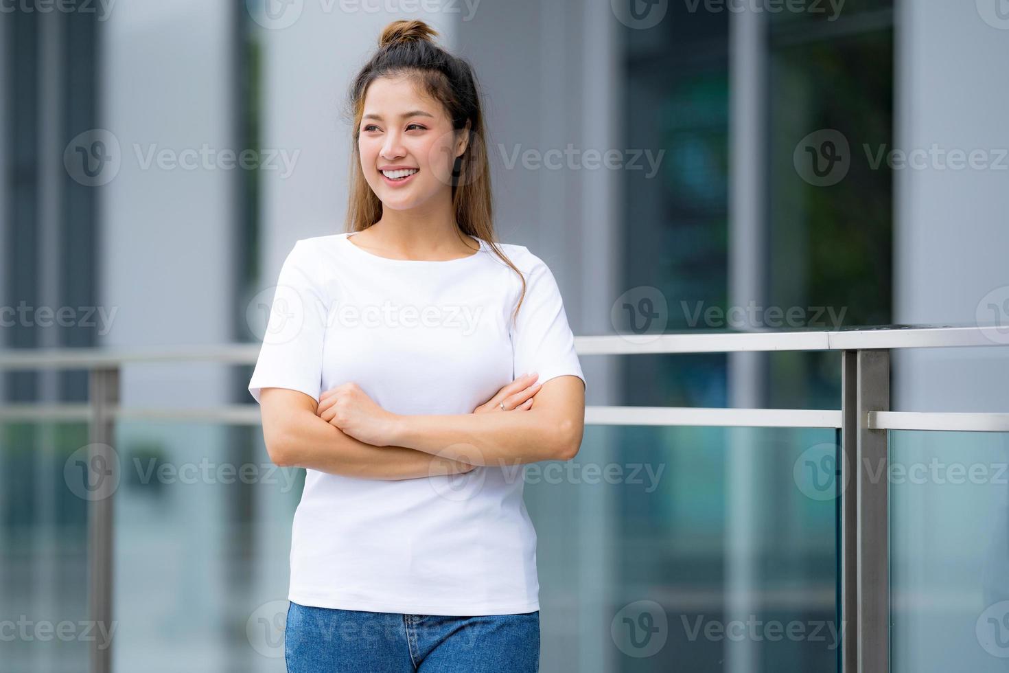 Woman in white t shirt and blue jeans photo