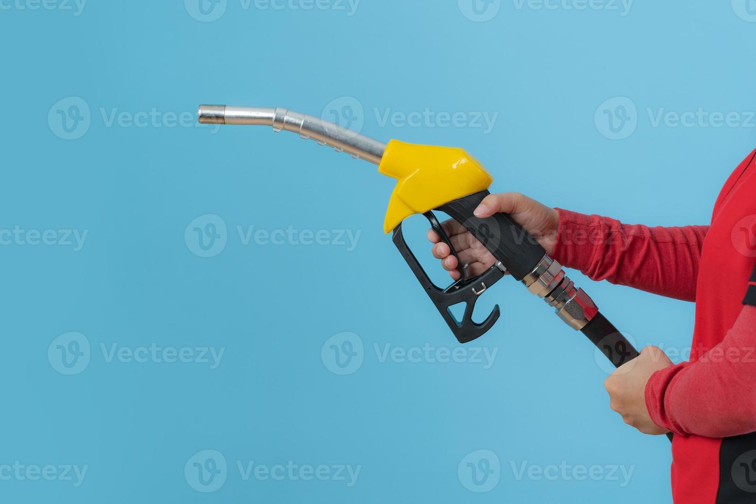 Woman hold fuel nozzle on blue background photo