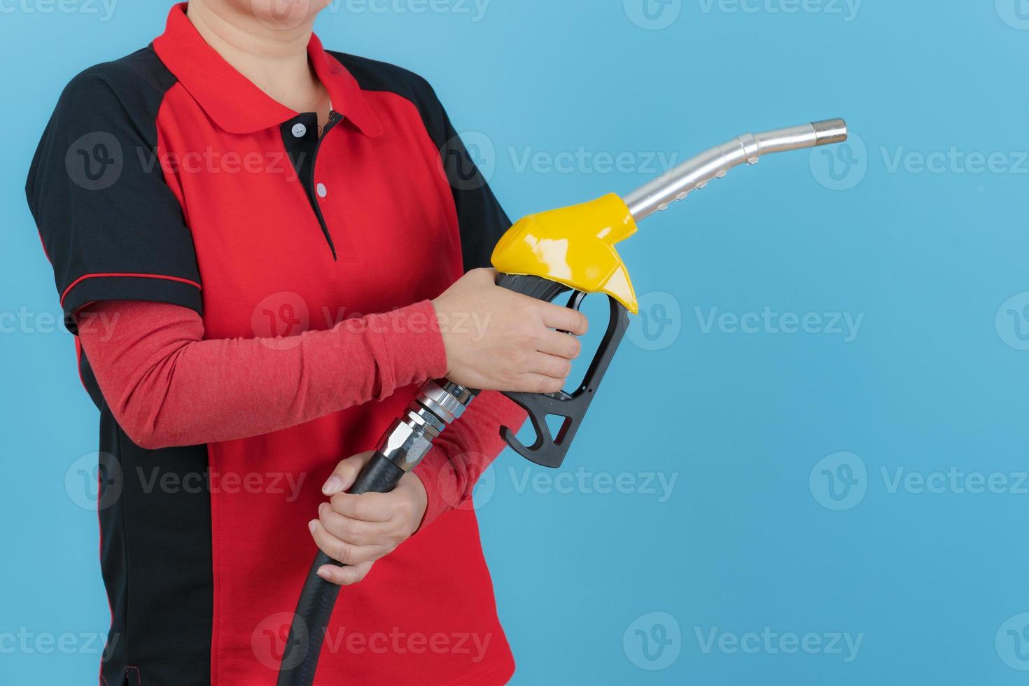 Woman hold fuel nozzle on blue background photo