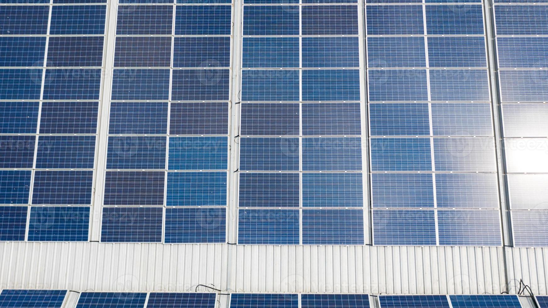 Aerial top view of the solar cells on the roof photo