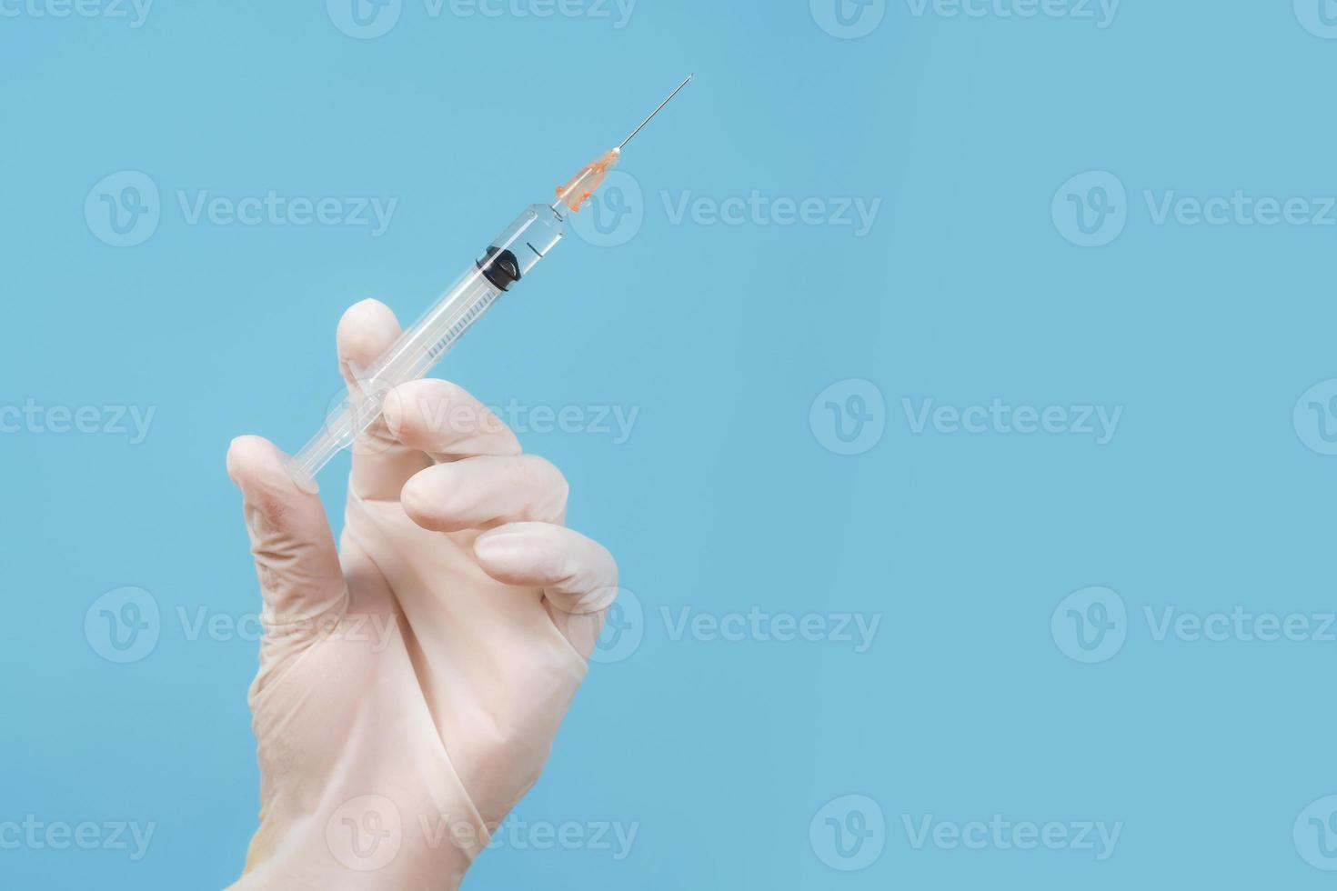 Syringe in doctor hand photo