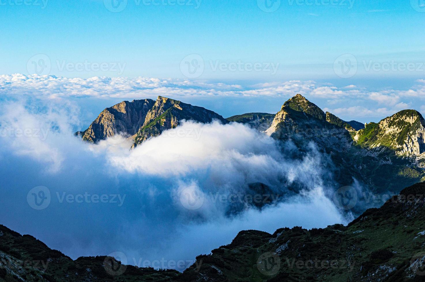 Clouds amongst mountains photo