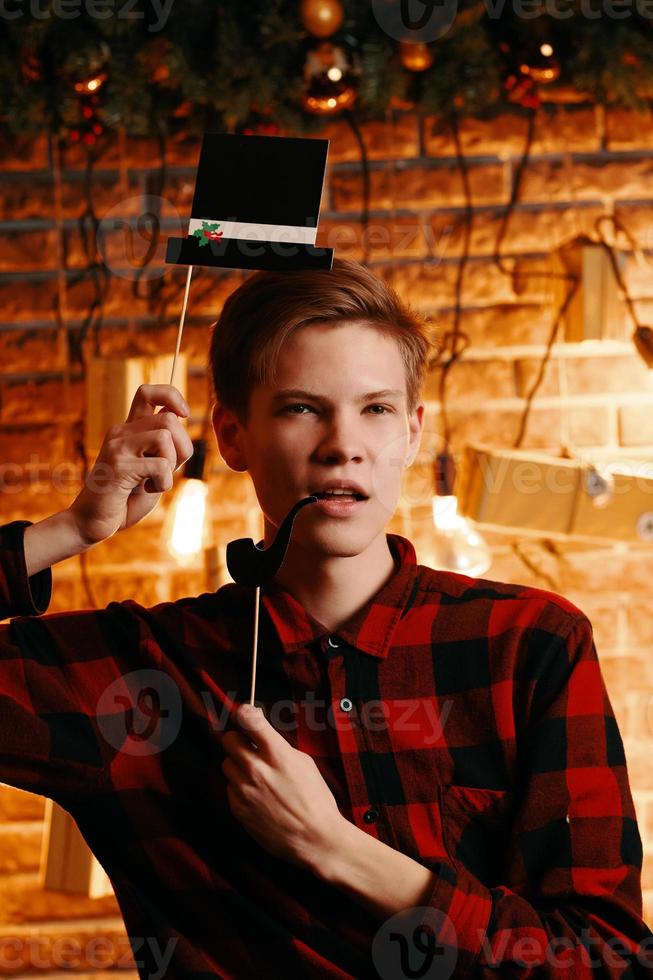 Handsome guy posing with top hat and pipe photo booth attributes