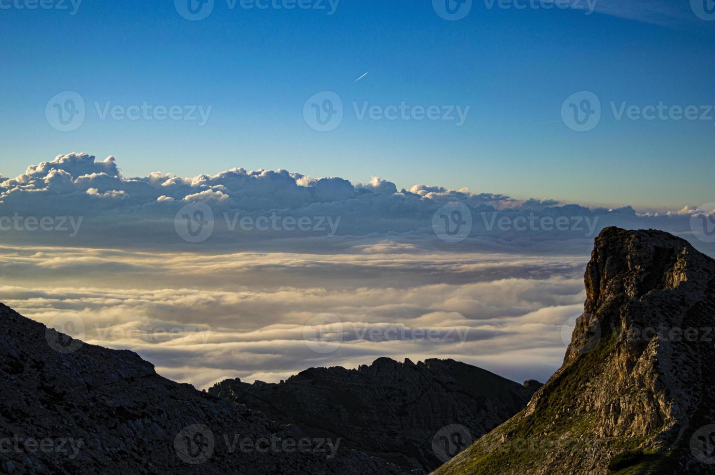 Clouds and mountains at twilight photo