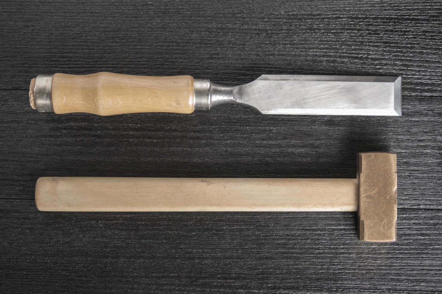 chisel and bronze mallet on a black background joiner workshop photo