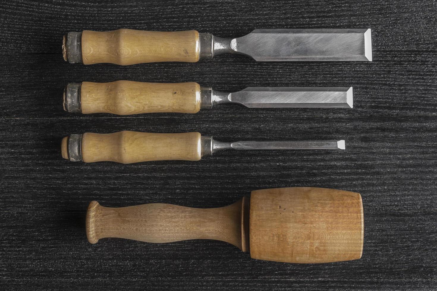 chisels and wooden mallet on a black background joiner workshop photo