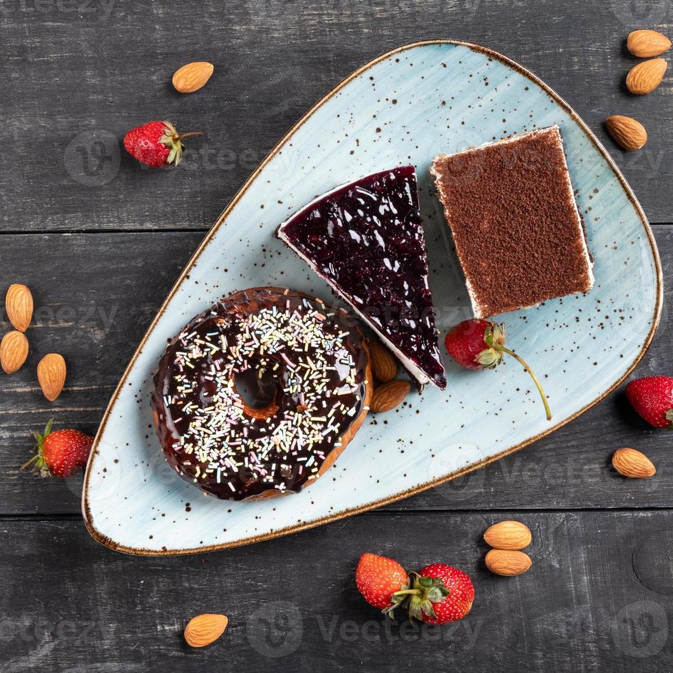 Beautiful doughnut, chocolate cake, and tiramisu, top view photo