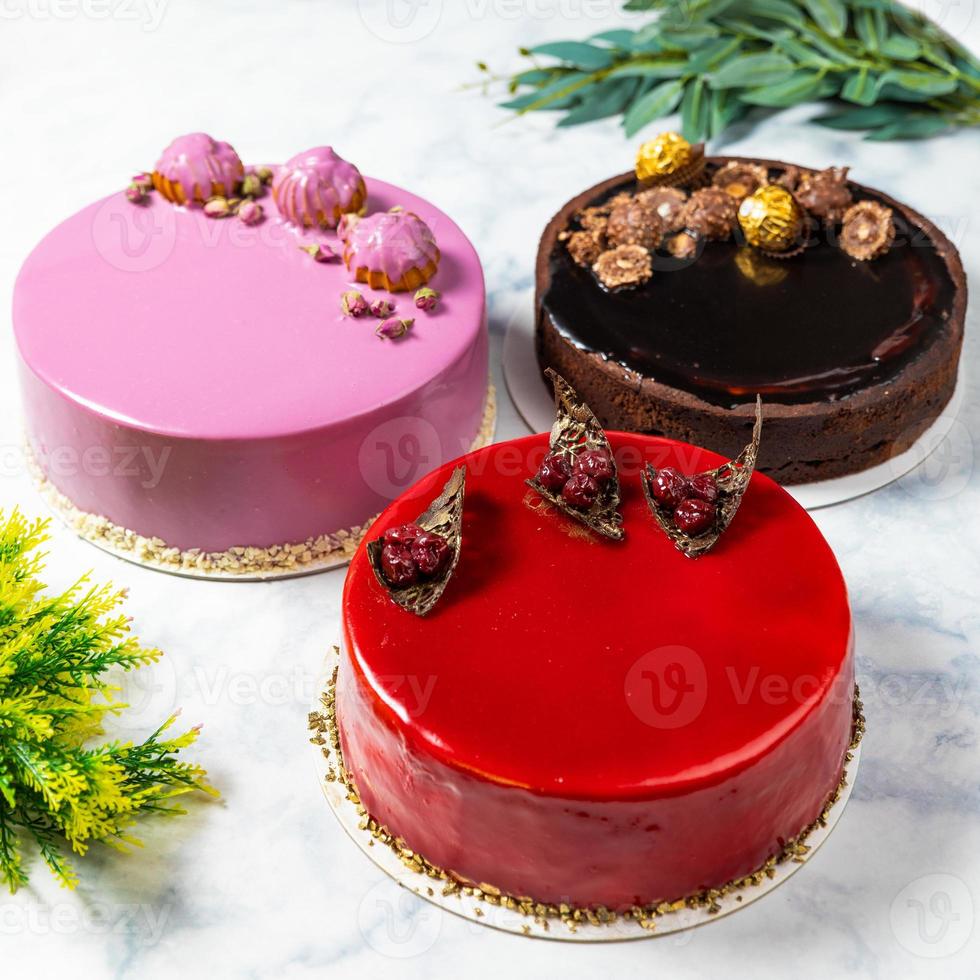 Different beautiful colorful cakes on the white table, top view photo