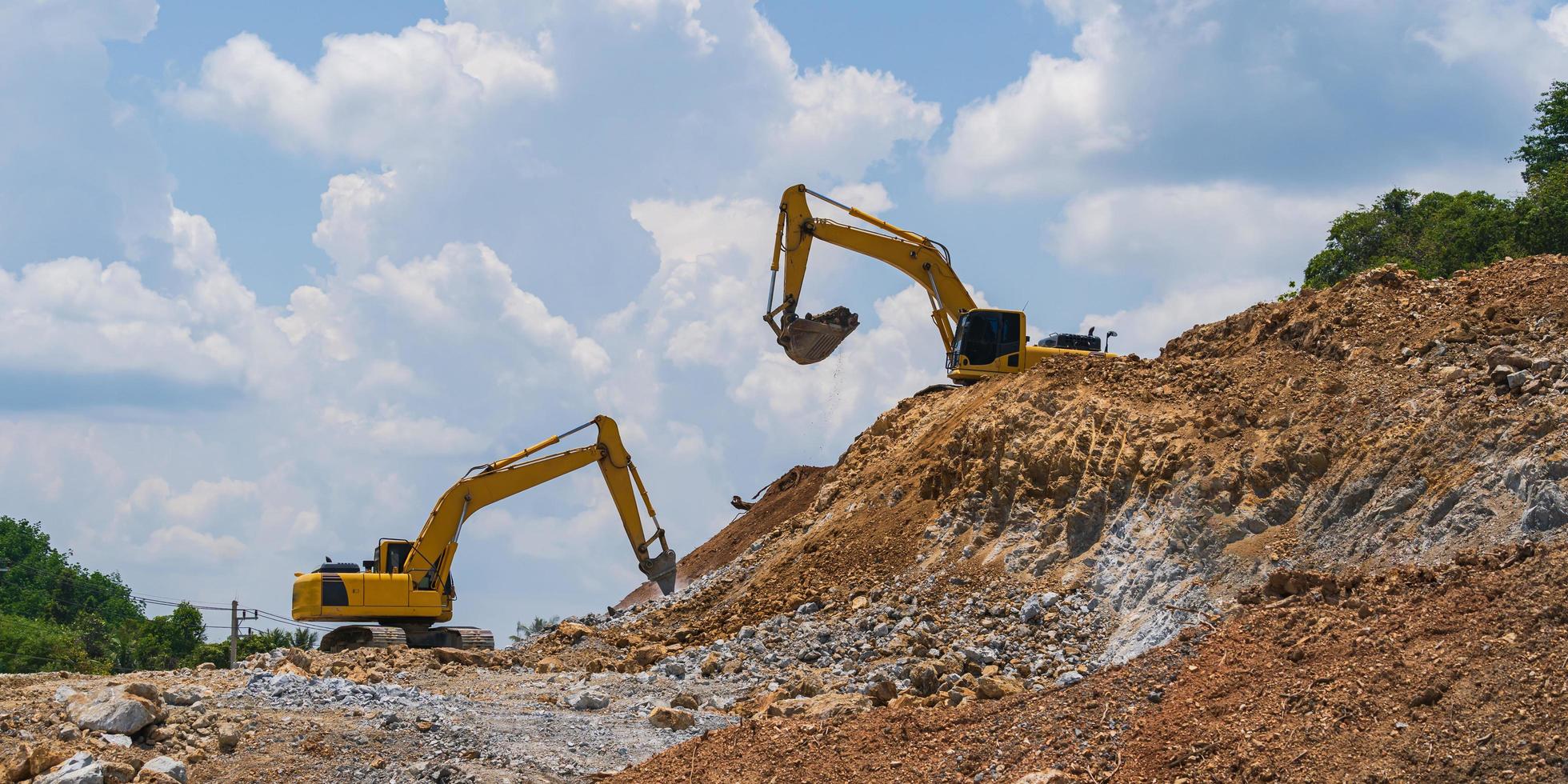 Excavator working outdoors under blue sky photo