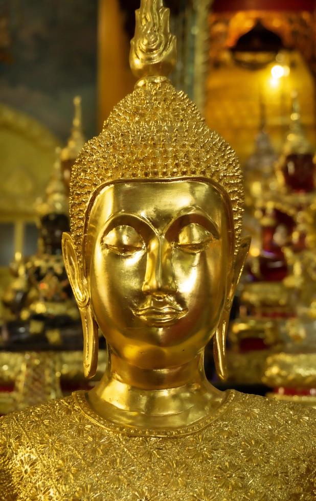 Buddha statue with blurred statues in the background photo