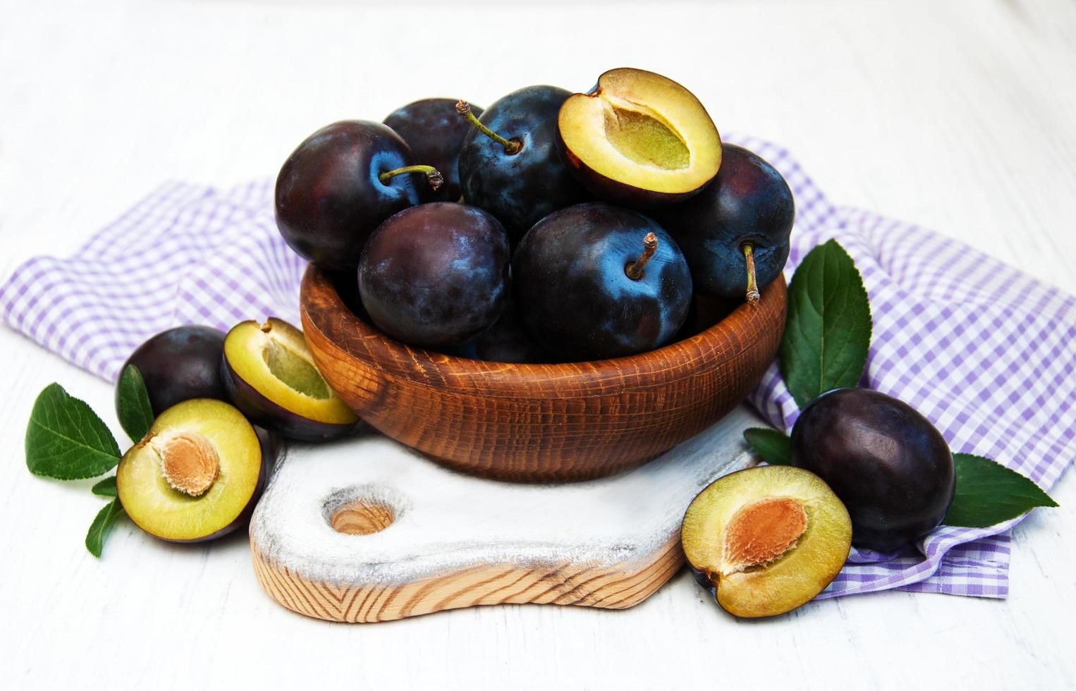 Sweet plums on an old wooden background photo