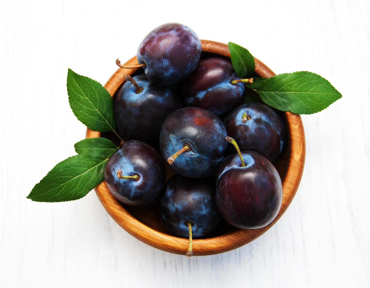 Sweet plums on a wooden background photo