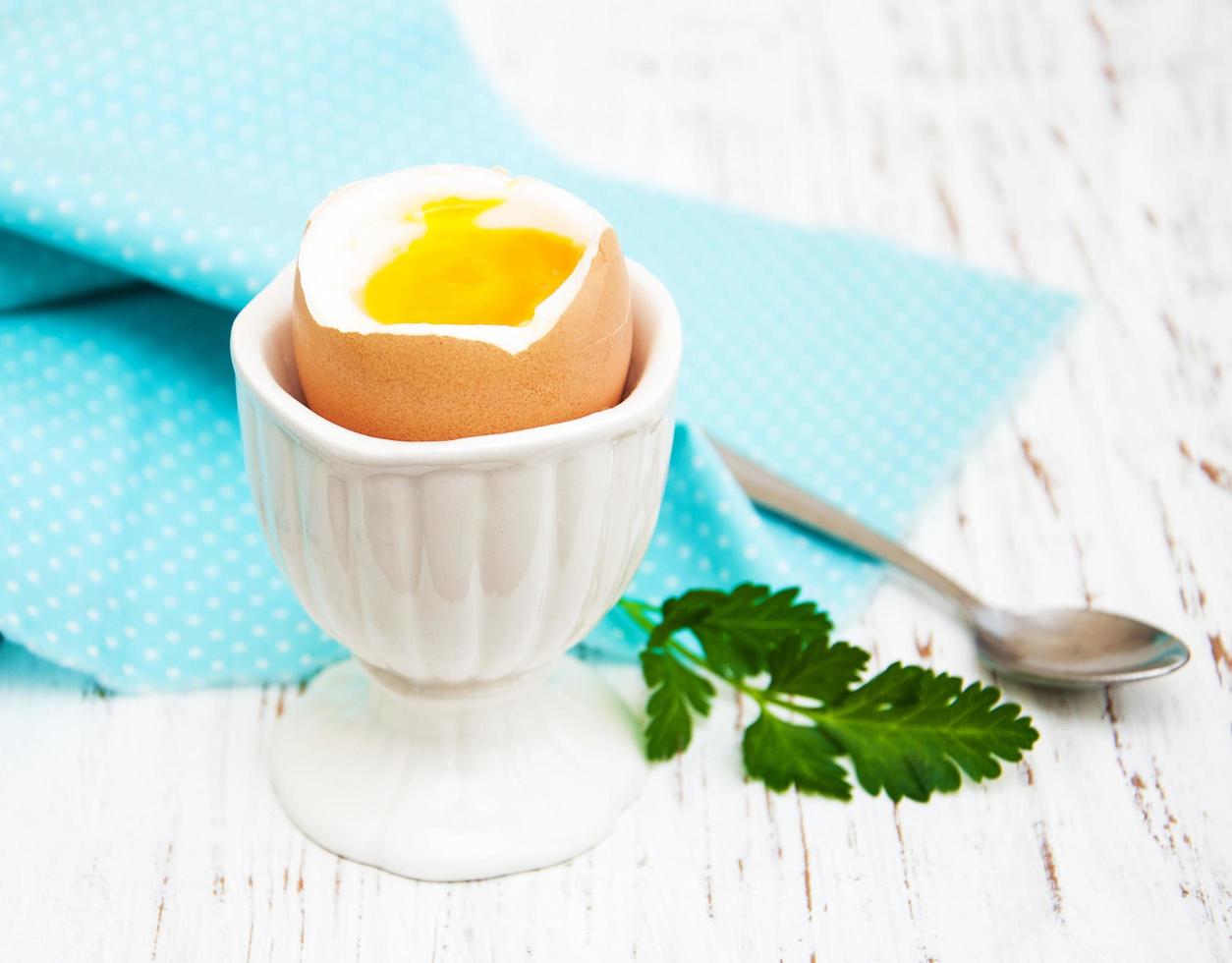 Boiled egg for breakfast on an old wooden table photo