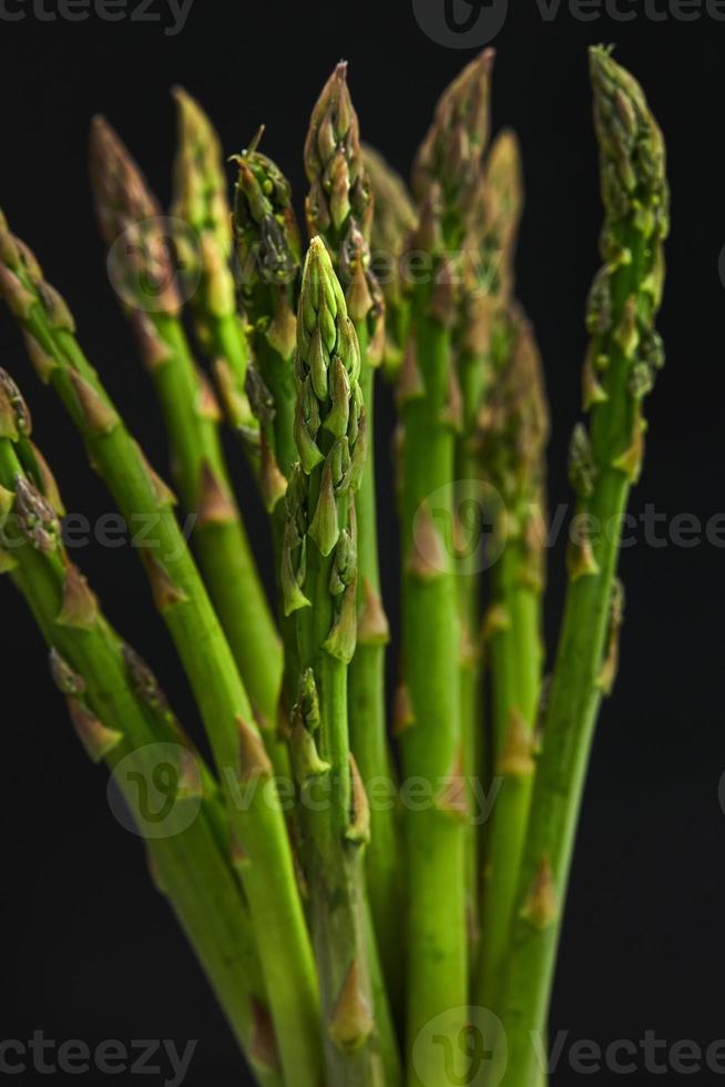 Bunch of fresh asparagus on a concrete base photo