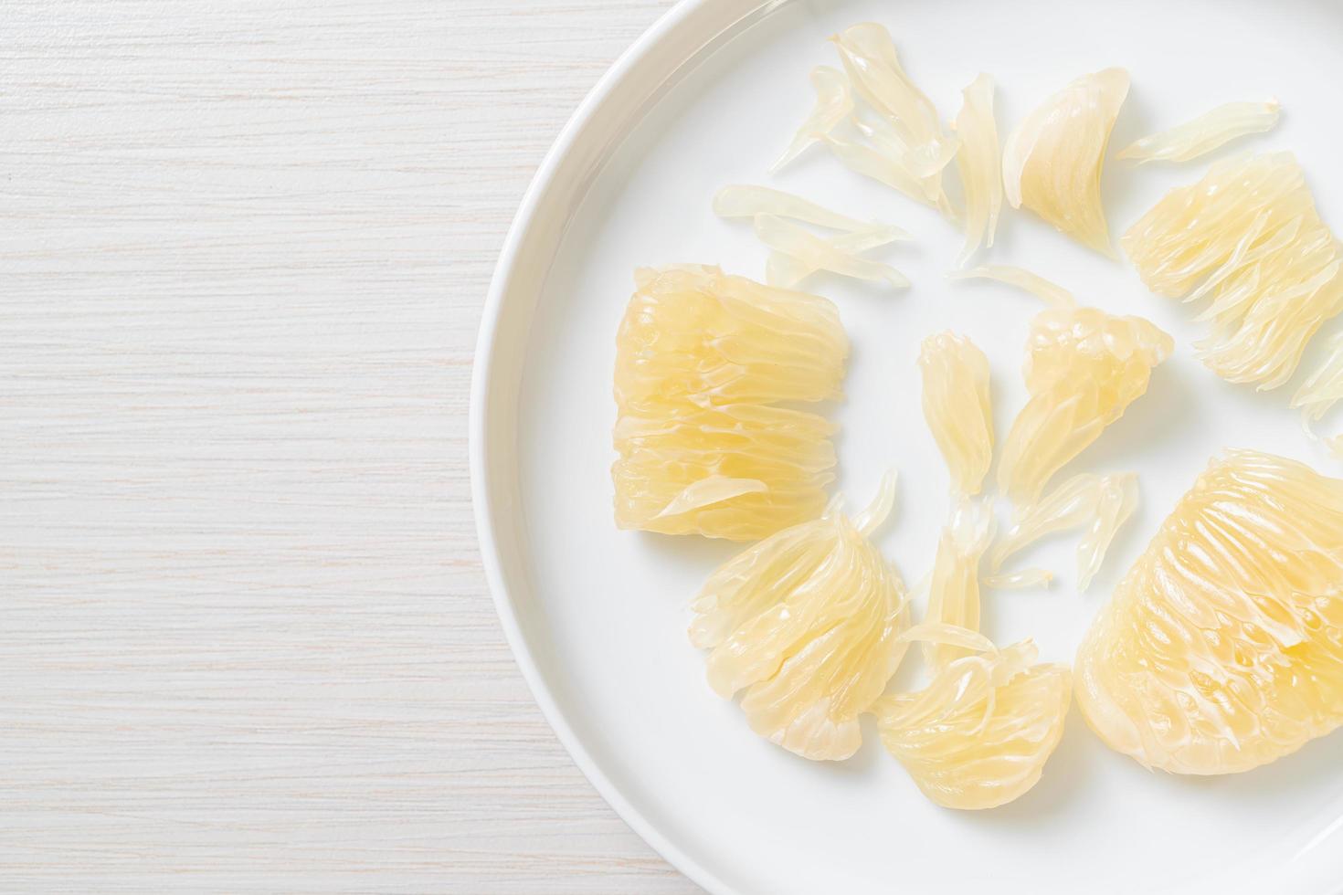 Fresh peeled pomelo grapefruit or shaddock photo