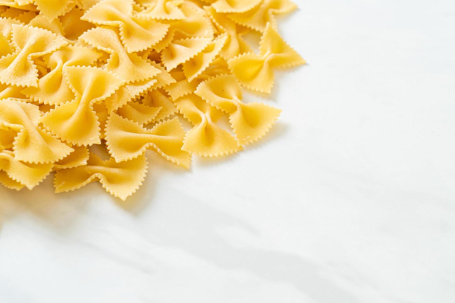 Dry uncooked farfalle pasta photo