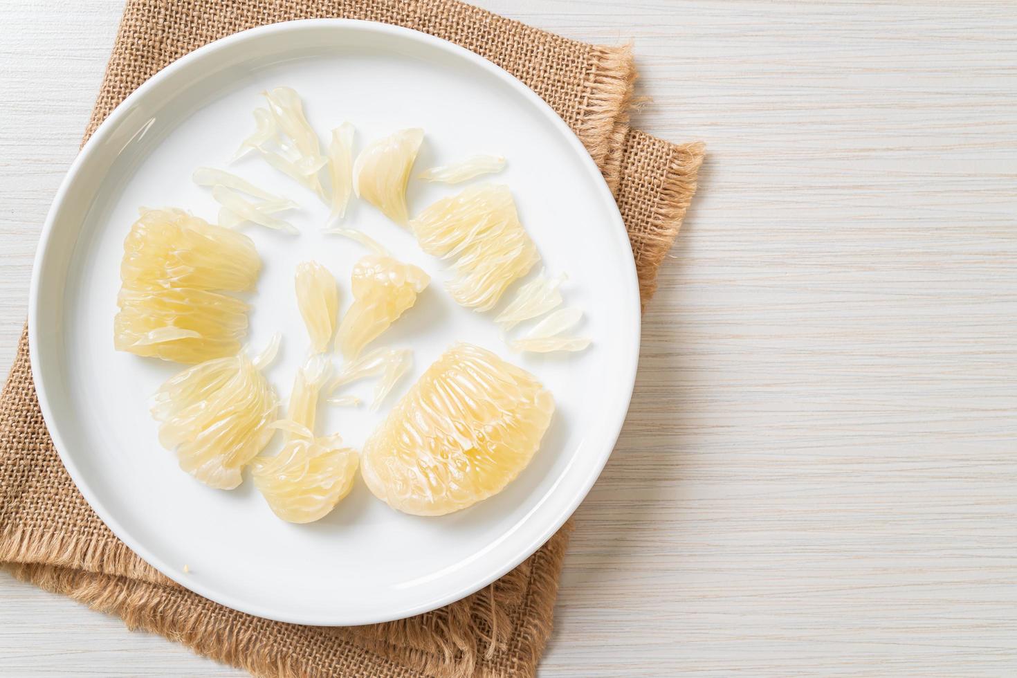 Fresh peeled pomelo grapefruit or shaddock photo