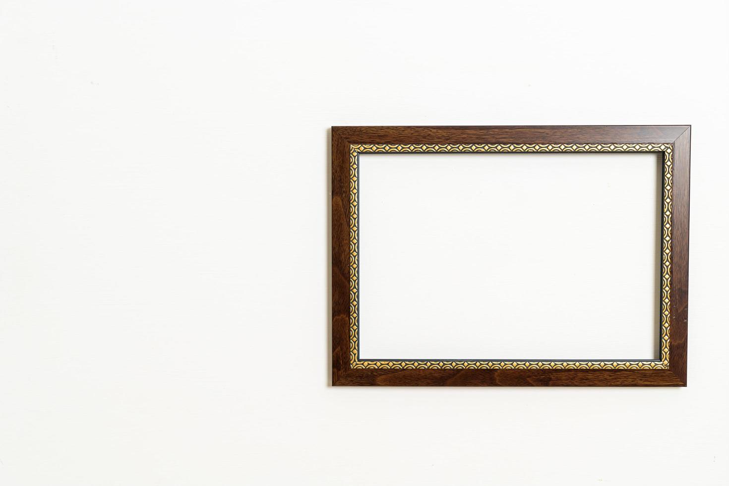 Empty picture frame on white wall background with copy space photo