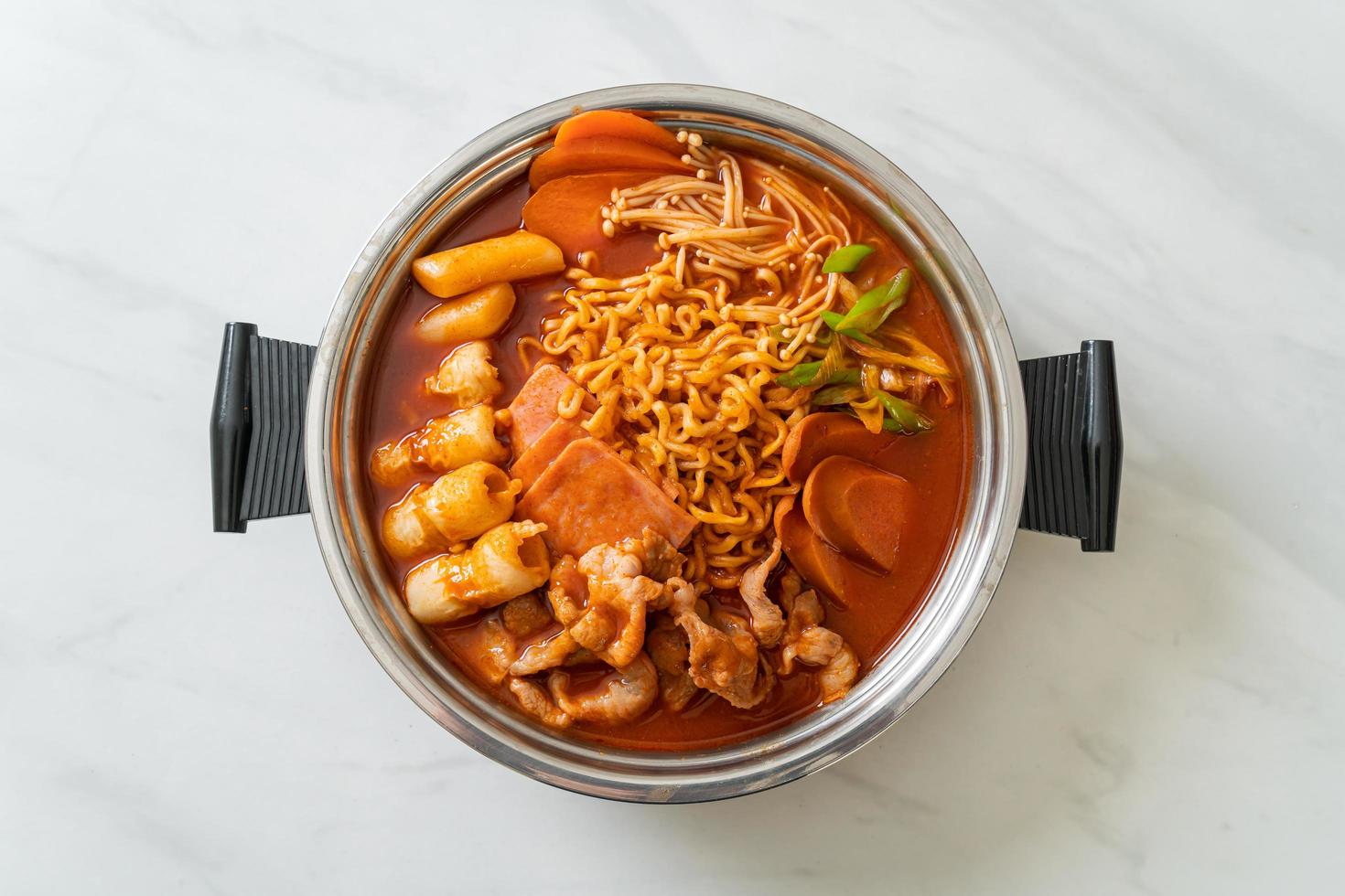 Budae Jjigae or Budaejjigae, Army stew or Army base stew, with kimchi, spam, sausages, ramen noodles, and more - popular Korean hot pot food style photo