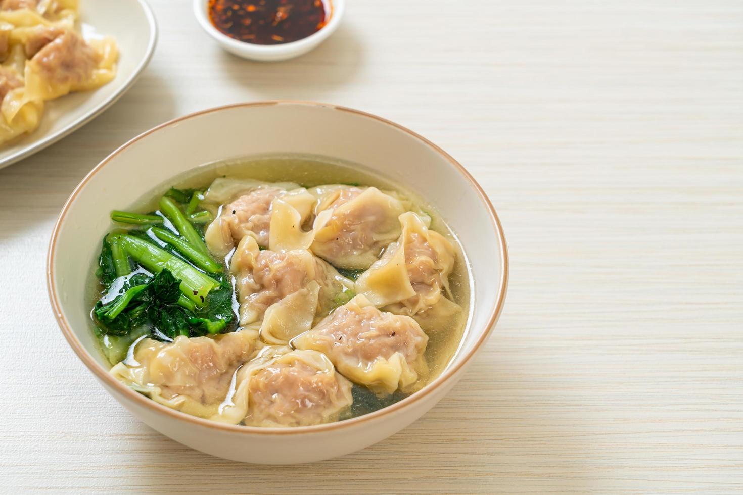 Pork wonton soup or pork dumplings soup with vegetable - Asian food style photo