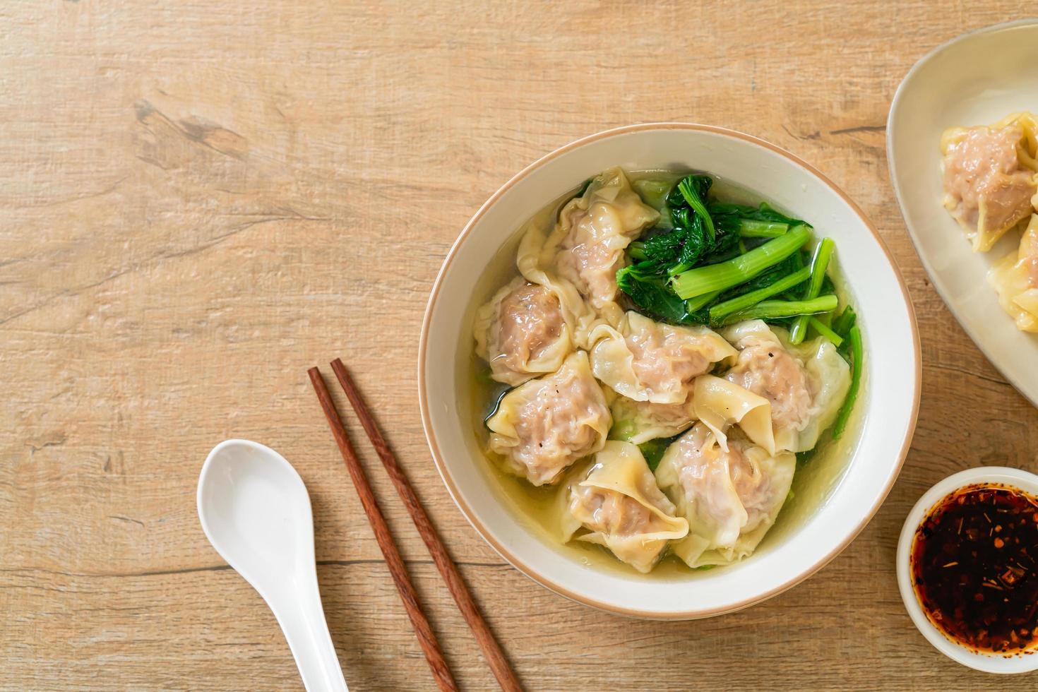 Pork wonton soup or pork dumplings soup with vegetable - Asian food style photo