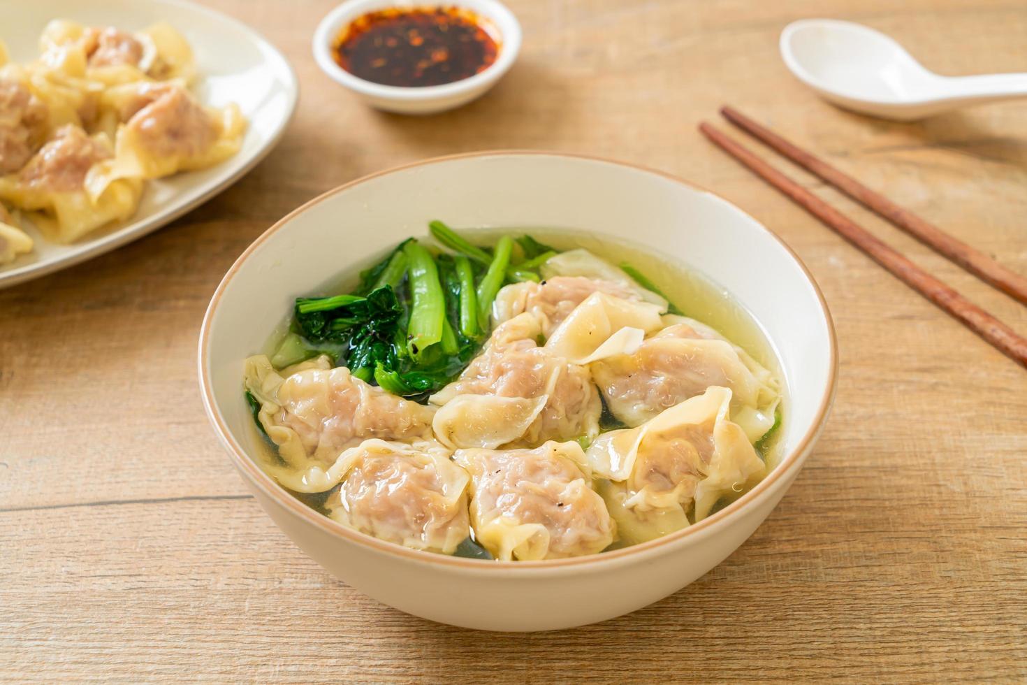 Pork wonton soup or pork dumplings soup with vegetable - Asian food style photo