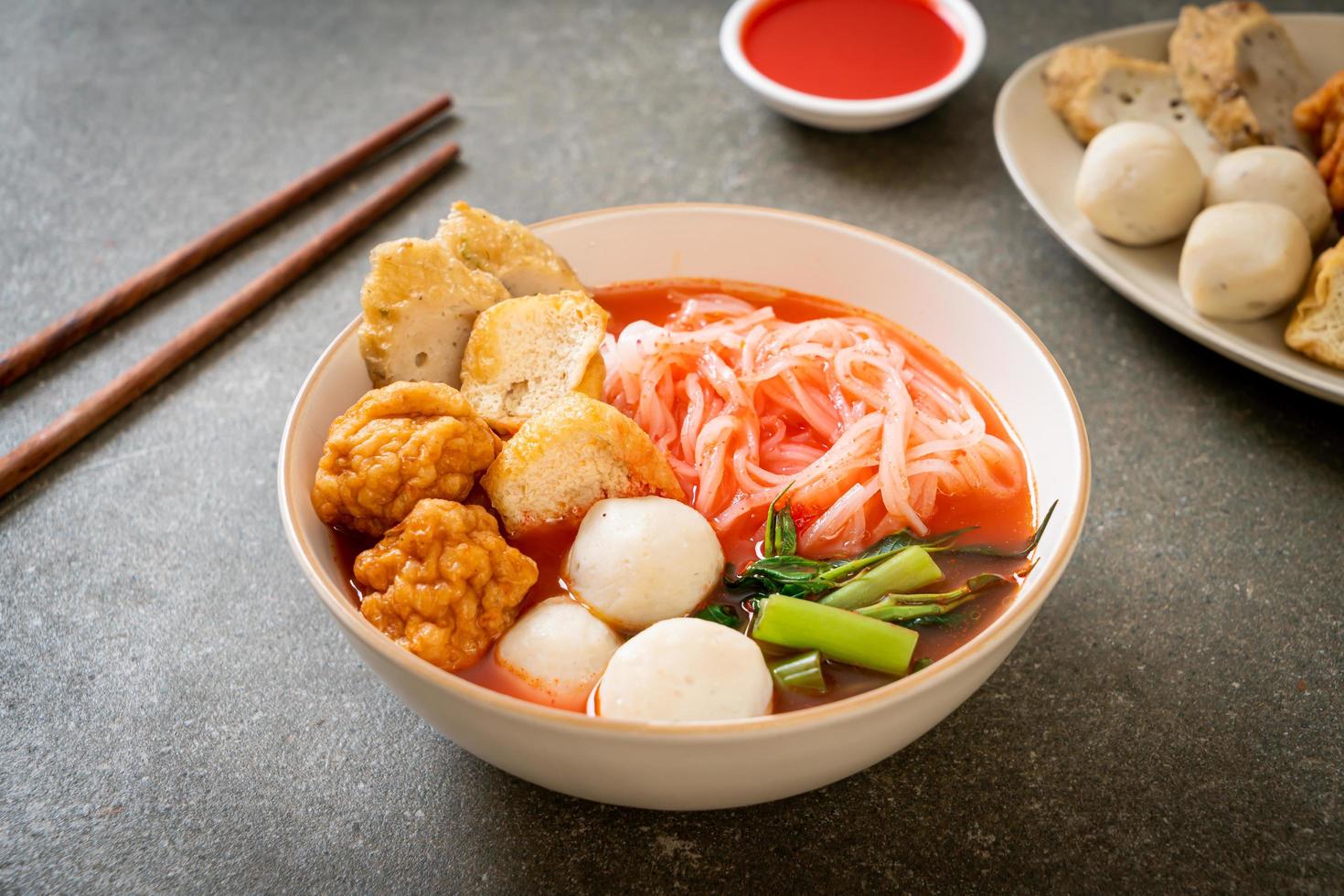 Small flat rice noodles with fish balls and shrimp balls in pink soup, Yen Ta Four or Yen Ta Fo - Asian food style photo