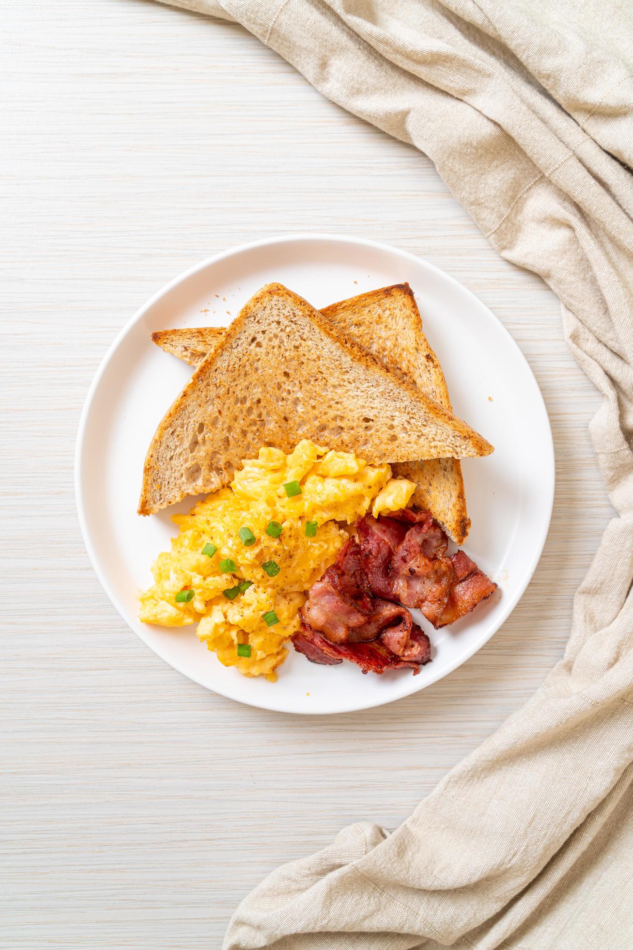 Scrambled Egg And Bacon With Toasted Bread Stock Photo At Vecteezy