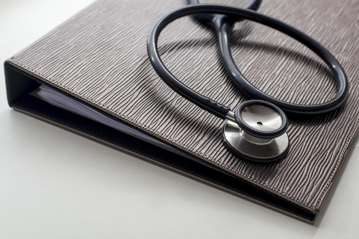 Stethoscope and file on gray table photo