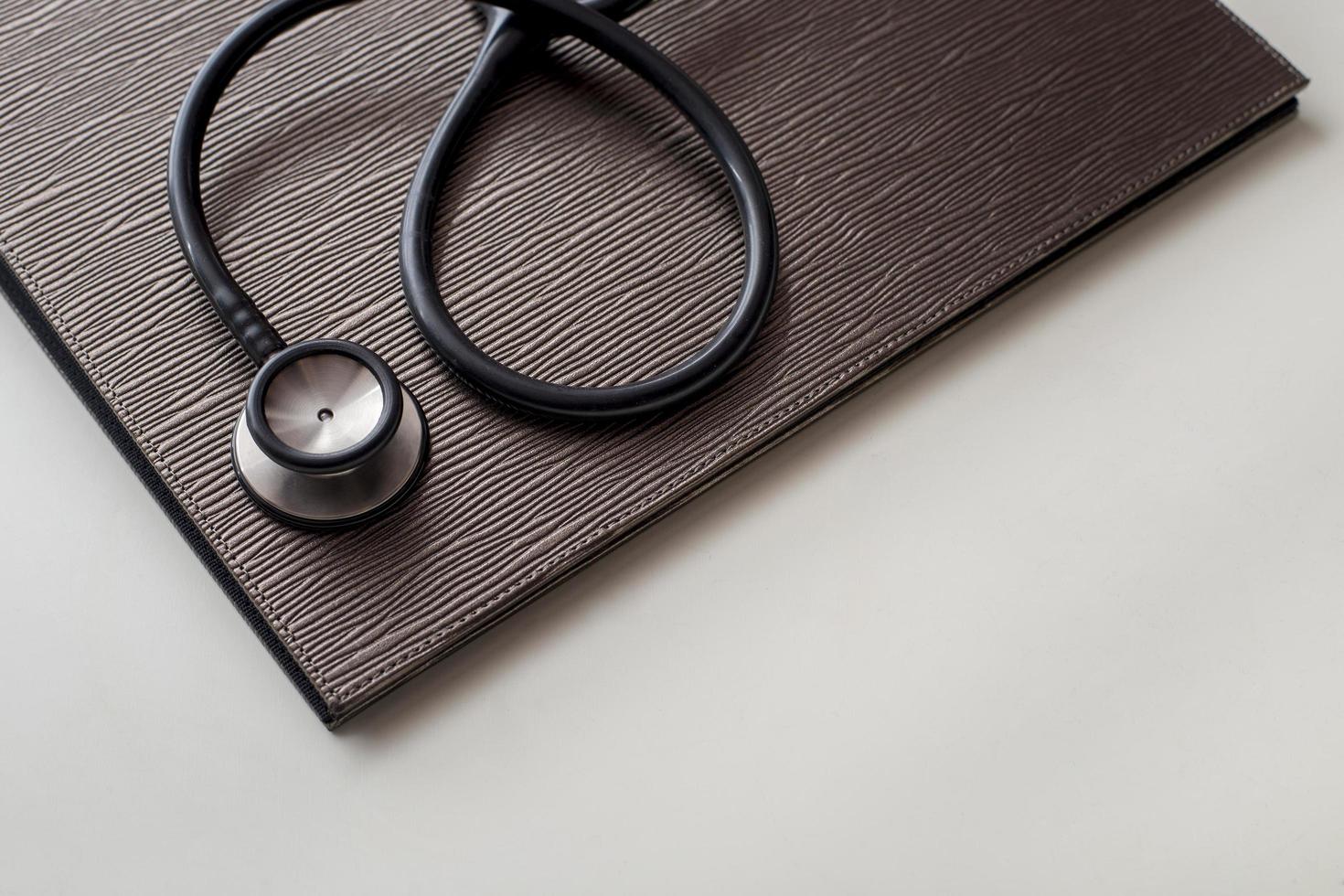 Stethoscope and file on gray table photo