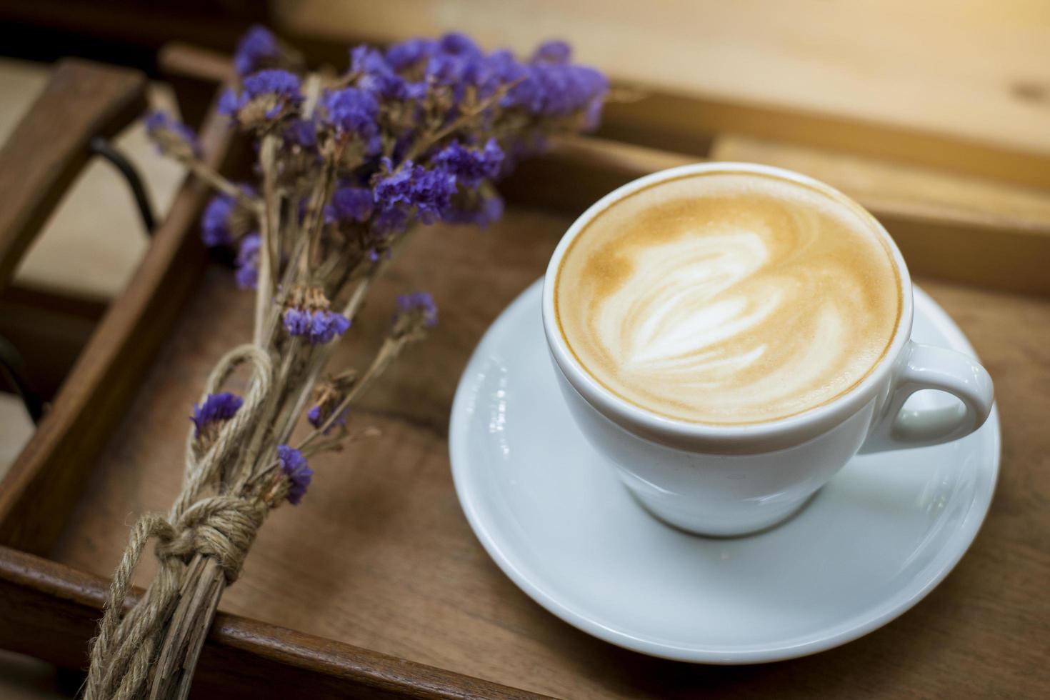 Hot latte art on wood table background photo