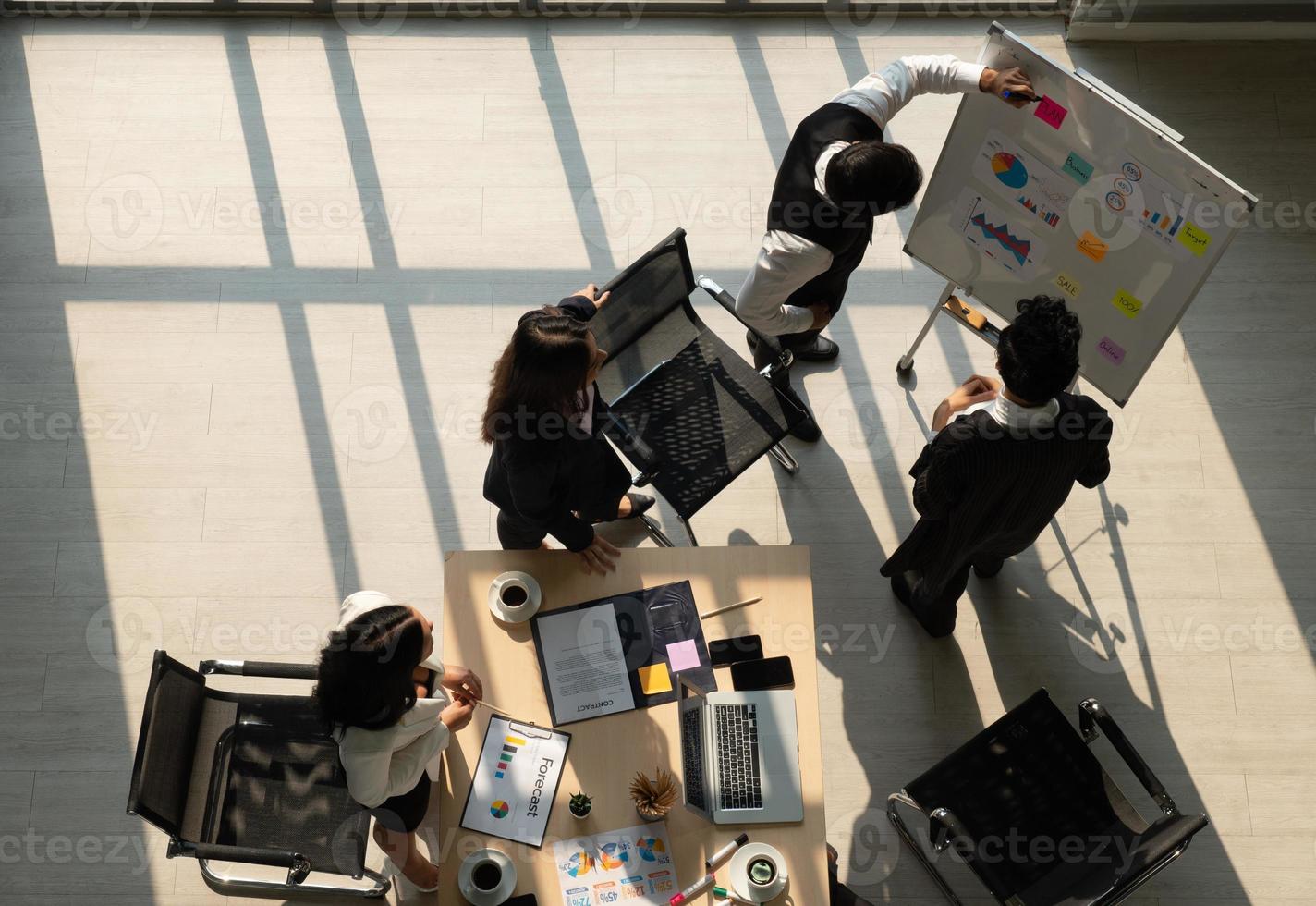 View from above of multiethnic business team including caucasian and asian people working together in office photo