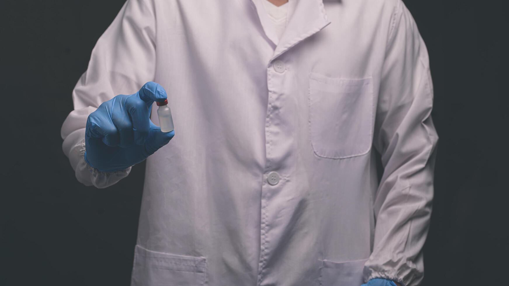 Doctor holds a bottle of vaccine medicine photo