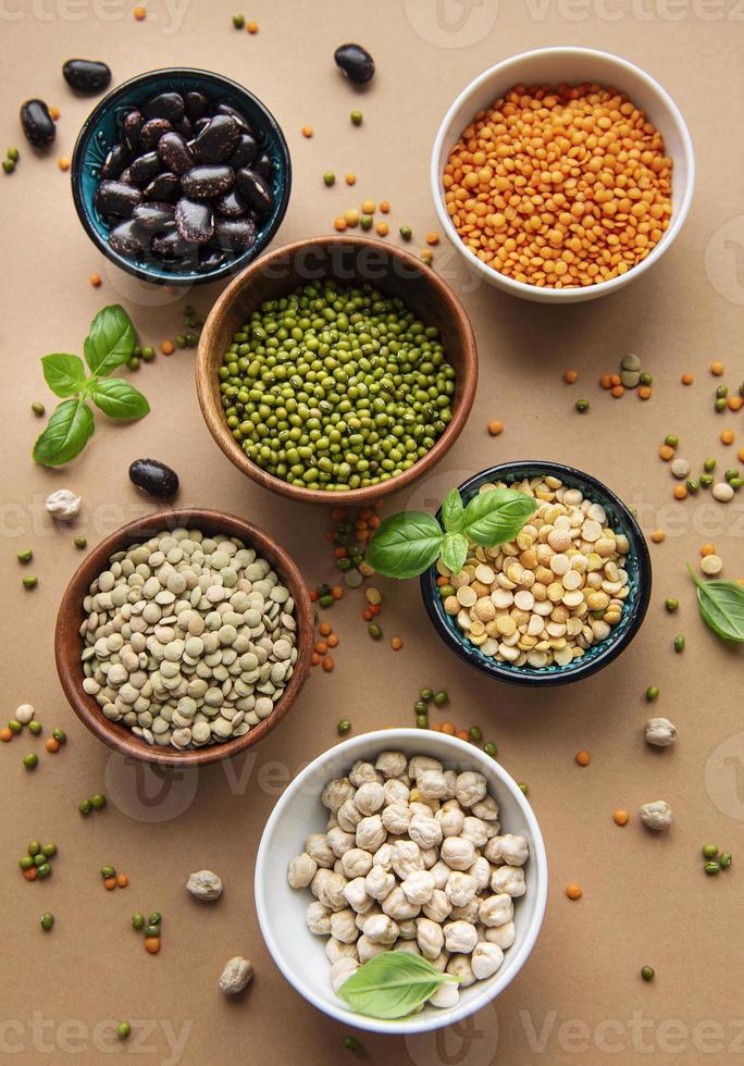 Bowls with different types of legumes photo