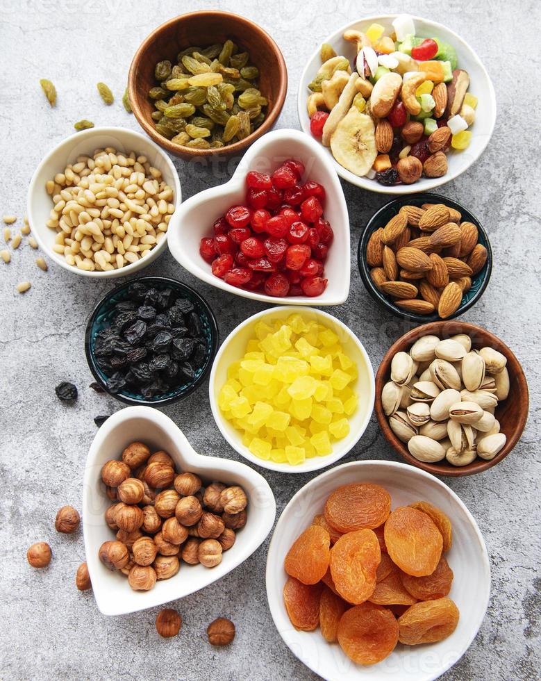 Bowls with various dried fruits and nuts photo