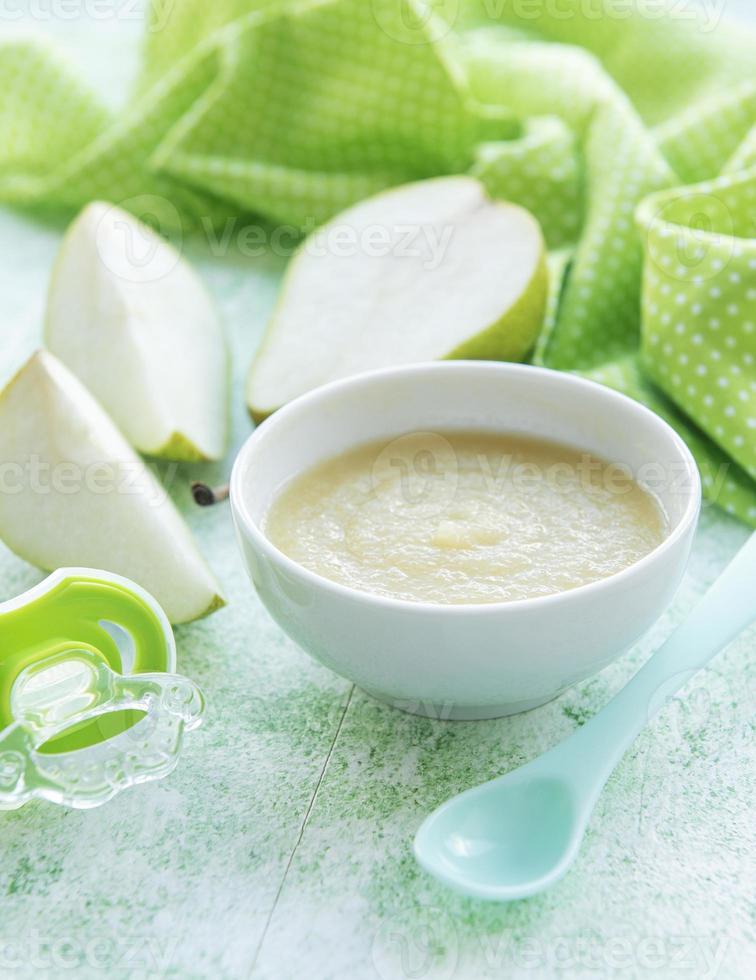 Bowl with fruit baby food and pears photo