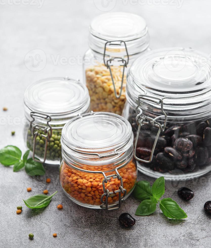 Glass jars  with different types of legumes photo