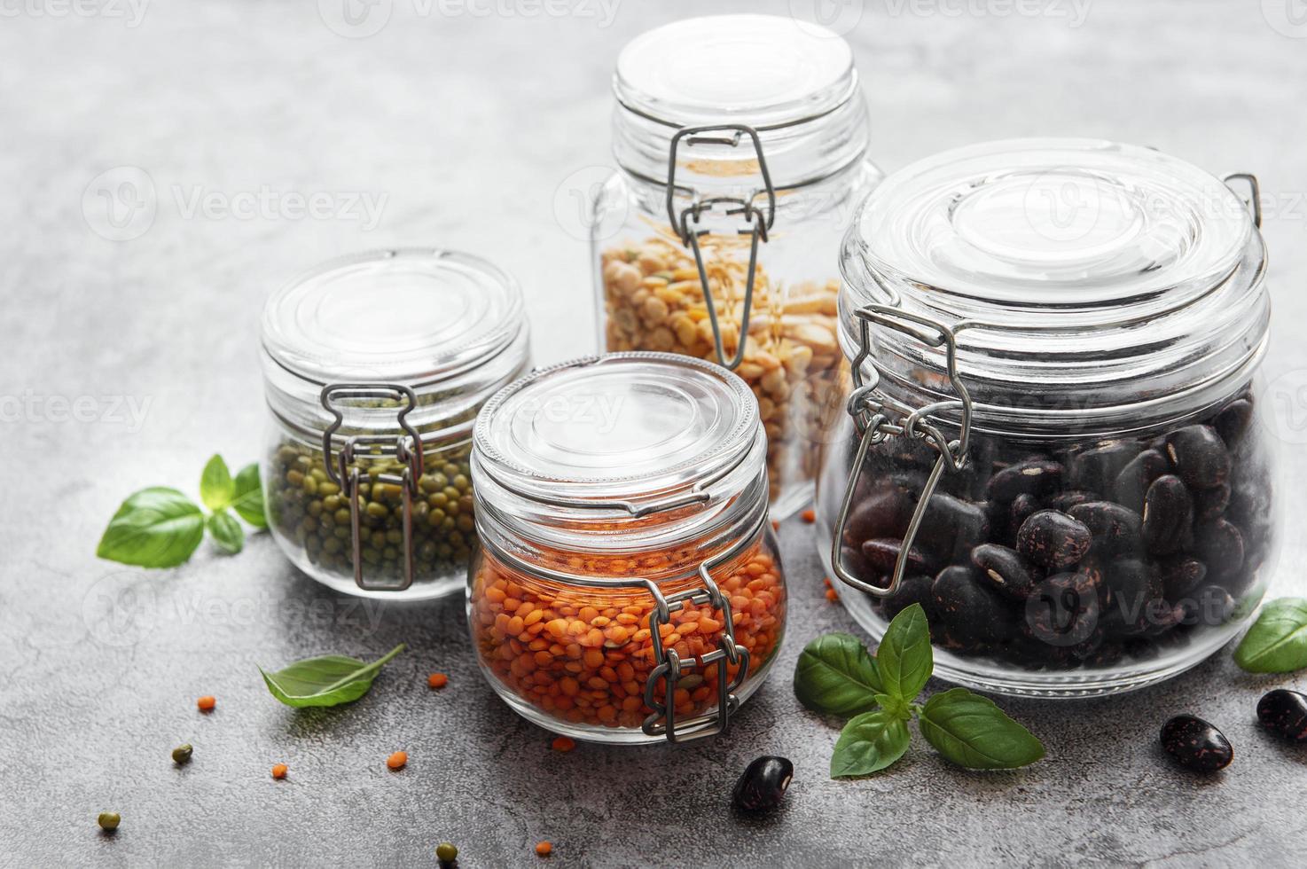 Glass jars  with different types of legumes photo
