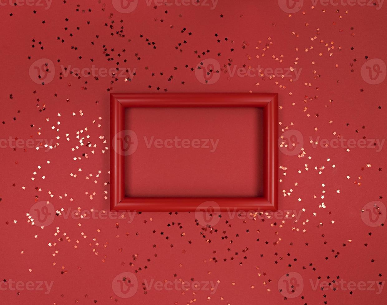 Frame and confetti stars on a red background photo